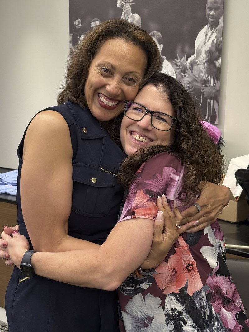 DawnMarie Montgomery embracing a friend and colleague